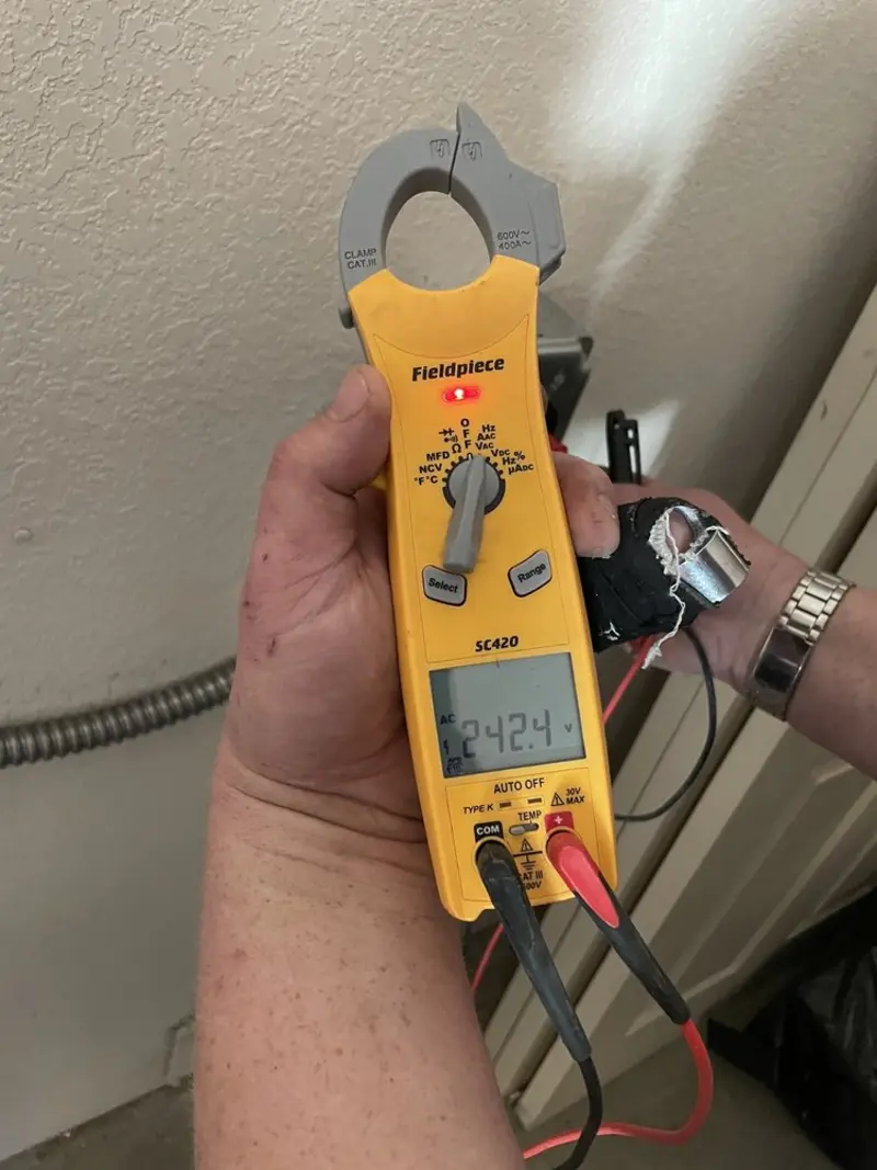 Voltage testing with clamp meter during Ceiling Fan Installation in Woodinville